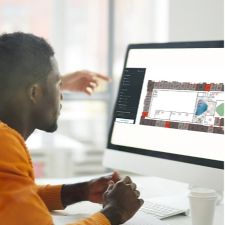 Young man browsing Pynwheel interactive property website map on his home computer