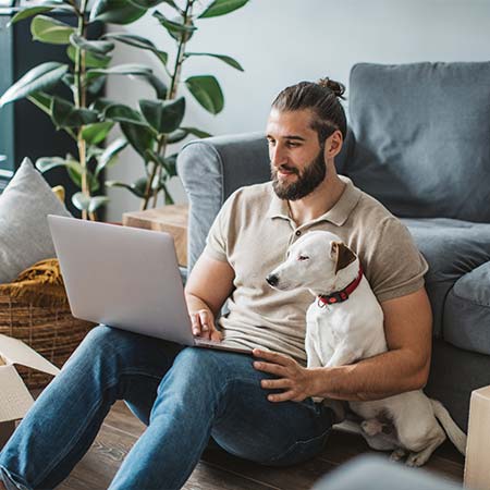 Young man browsing Pynwheel interactive property website map on his home computer