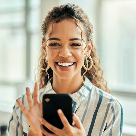 Happy woman wearing sunglasses using self-guided tour app